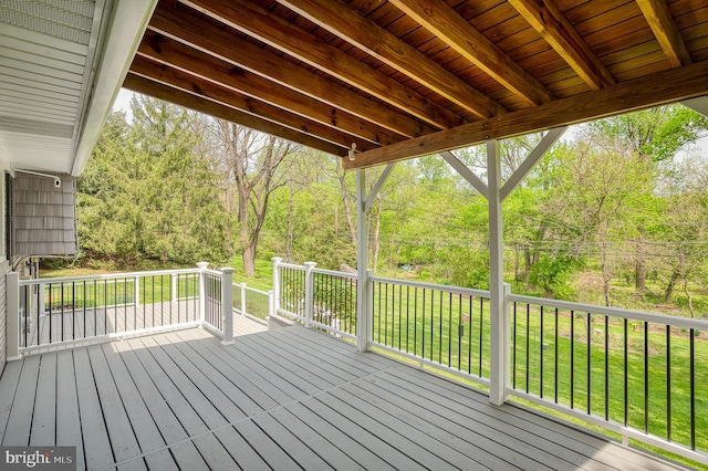wooden terrace featuring a yard