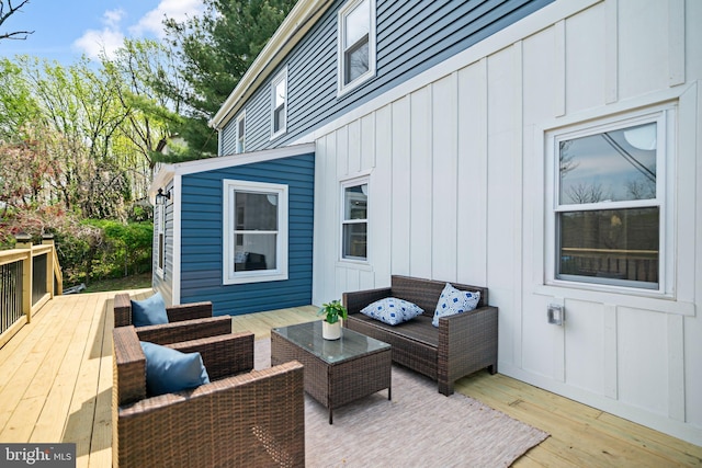 wooden deck with an outdoor living space