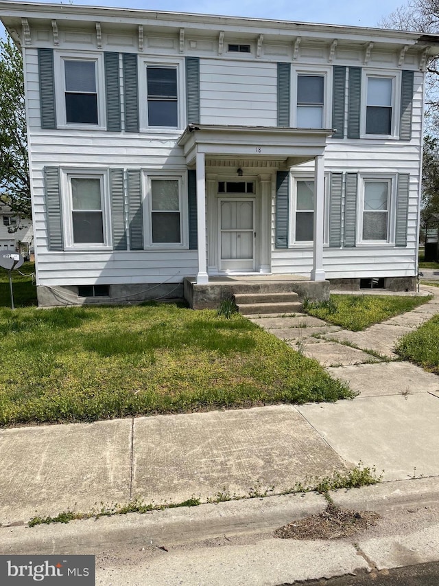 italianate house featuring a porch and a front lawn