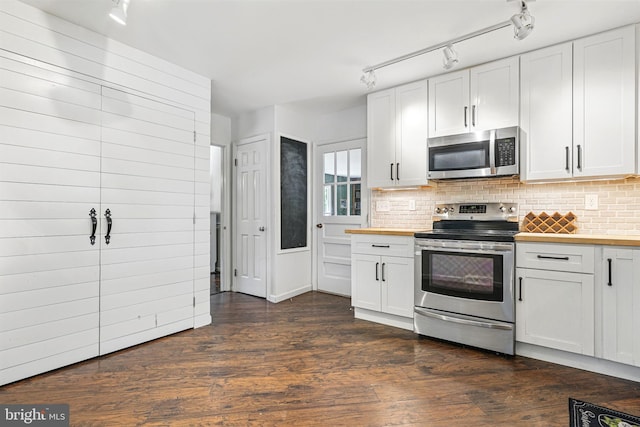 6611 Jupiter Dr, Huntingtown, MD 20639 - kitchen with appliances with stainless steel finishes, rail lighting, decorative backsplash, dark wood-style floors, and butcher block counters