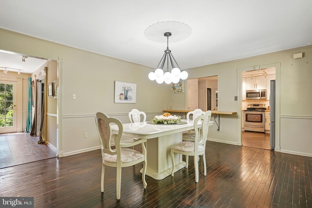 6611 Jupiter Dr, Huntingtown, MD 20639 - dining area with baseboards, a chandelier, track lighting, and dark wood-type flooring