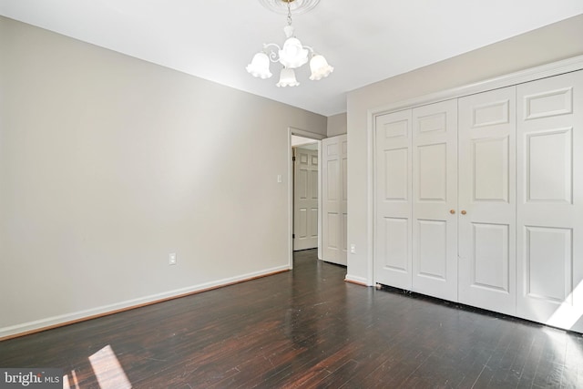 6611 Jupiter Dr, Huntingtown, MD 20639 - unfurnished bedroom featuring baseboards, a chandelier, hardwood / wood-style flooring, and a closet