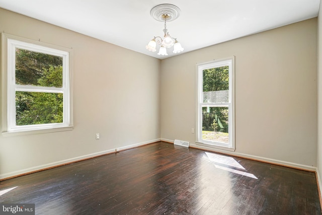 6611 Jupiter Dr, Huntingtown, MD 20639 - spare room featuring visible vents, baseboards, hardwood / wood-style flooring, and an inviting chandelier