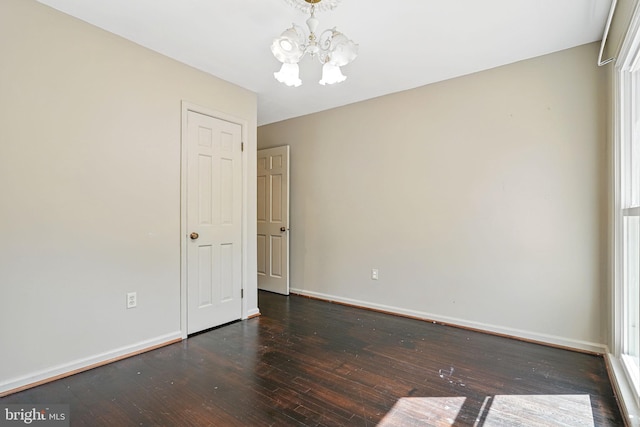 6611 Jupiter Dr, Huntingtown, MD 20639 - unfurnished room featuring wood-type flooring, baseboards, and a notable chandelier