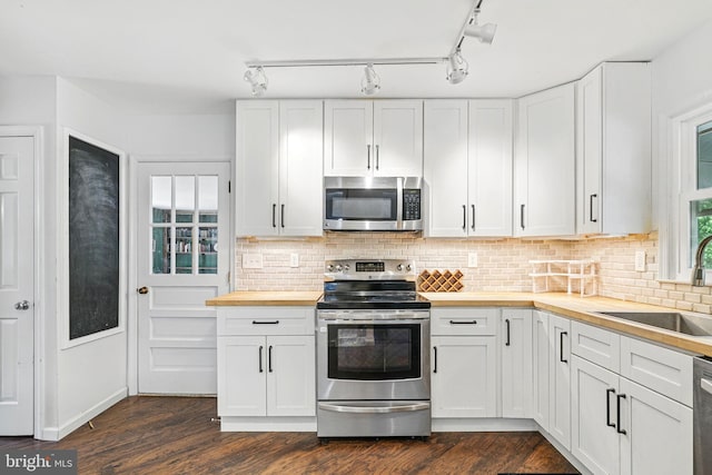 6611 Jupiter Dr, Huntingtown, MD 20639 - kitchen with backsplash, stainless steel appliances, butcher block countertops, and a sink