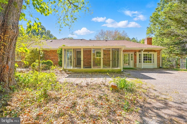 6611 Jupiter Dr, Huntingtown, MD 20639 - back of house featuring fence, a chimney, a sunroom, and brick siding