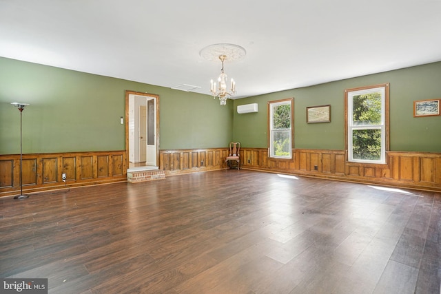 6611 Jupiter Dr, Huntingtown, MD 20639 - unfurnished room featuring visible vents, a wall mounted AC, wainscoting, wood finished floors, and a chandelier