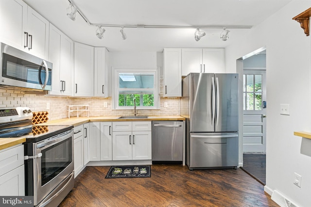 6611 Jupiter Dr, Huntingtown, MD 20639 - kitchen with a sink, appliances with stainless steel finishes, dark wood finished floors, and butcher block countertops