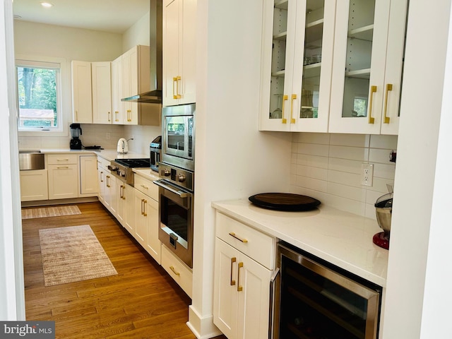 kitchen with stainless steel appliances, backsplash, dark wood-type flooring, and wine cooler