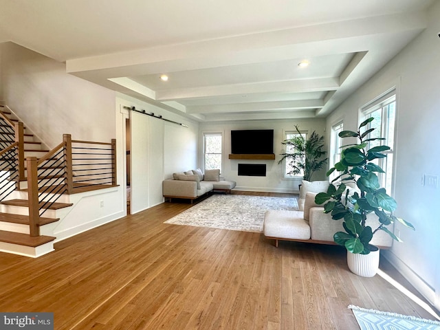 living area featuring recessed lighting, a barn door, wood-type flooring, stairs, and baseboards