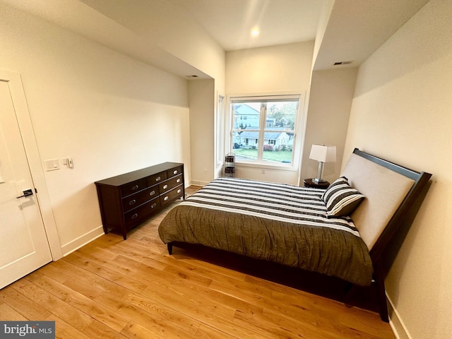 bedroom featuring recessed lighting, light wood finished floors, and baseboards