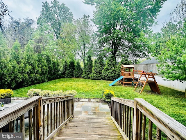 view of yard with fence and a playground