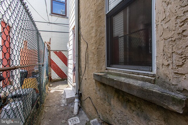 view of side of property featuring fence and entry steps