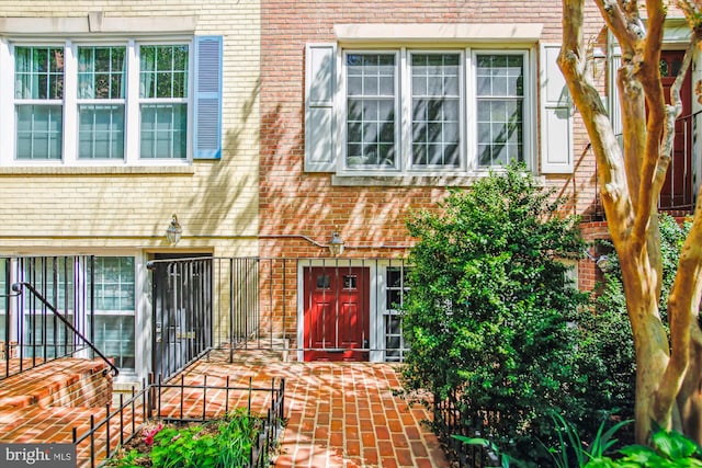 entrance to property featuring brick siding