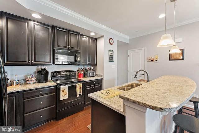 kitchen with a sink, black appliances, ornamental molding, a breakfast bar, and dark wood-type flooring