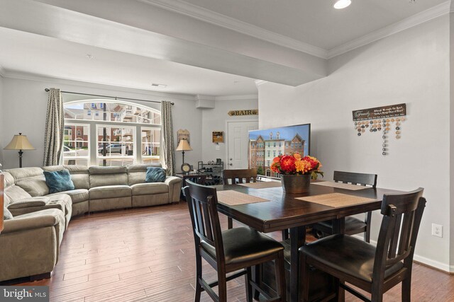 dining area with recessed lighting, ornamental molding, and wood finished floors