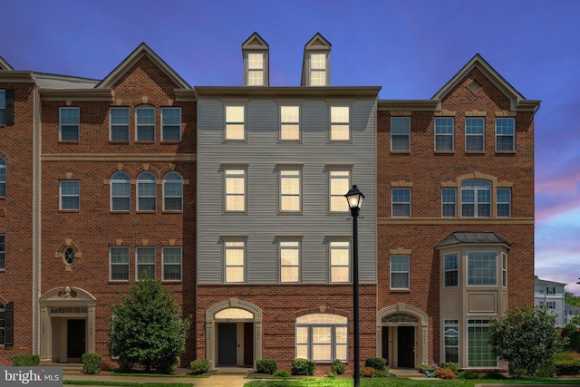 townhome / multi-family property with brick siding
