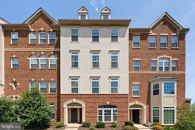 view of property featuring brick siding