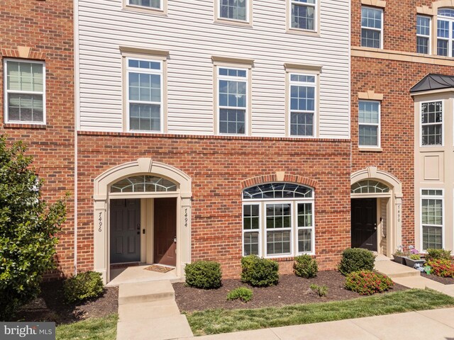 view of property with brick siding