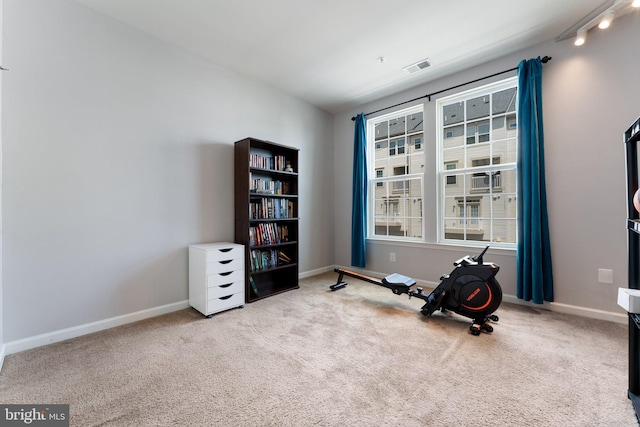 interior space with baseboards, visible vents, and carpet