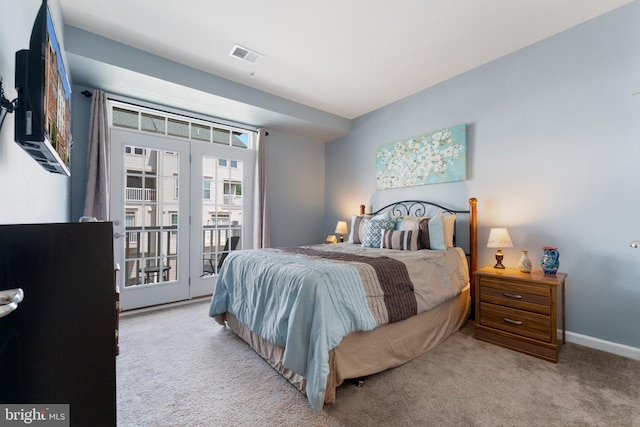 carpeted bedroom featuring baseboards, access to exterior, and visible vents