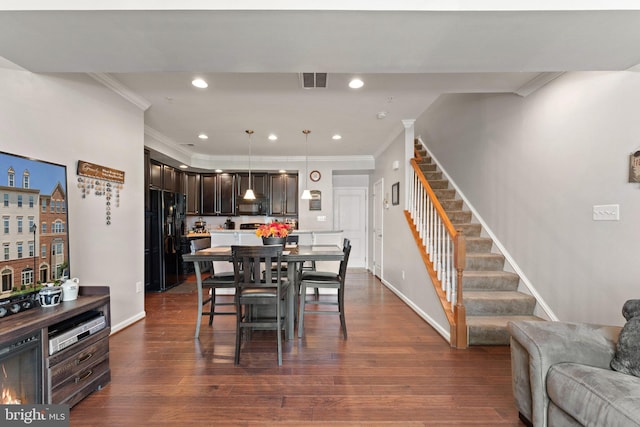 dining area featuring crown molding, stairs, baseboards, and visible vents