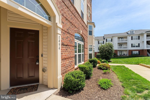 view of exterior entry with brick siding