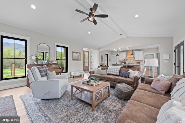 living area with light wood-style floors, lofted ceiling with beams, and recessed lighting