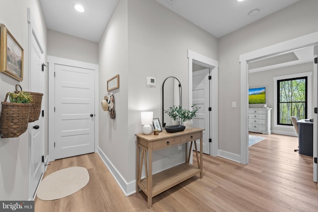 entrance foyer featuring light wood-type flooring, recessed lighting, and baseboards