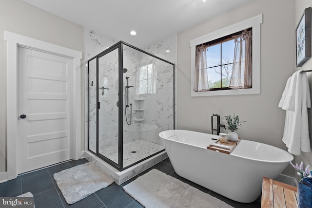 full bath featuring a freestanding bath, a marble finish shower, recessed lighting, and tile patterned floors