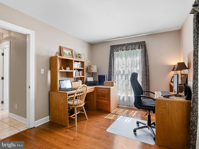 office area with wood finished floors and baseboards