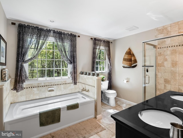 full bathroom with tile patterned flooring, toilet, vanity, a stall shower, and a garden tub