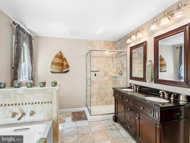 bathroom with double vanity, a washtub, a stall shower, and a sink