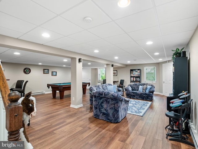 living room with plenty of natural light, baseboard heating, wood finished floors, and pool table