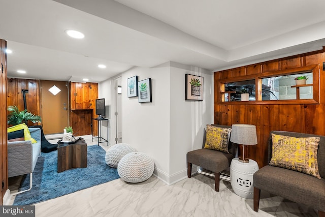 sitting room featuring a baseboard radiator, recessed lighting, marble finish floor, and baseboards