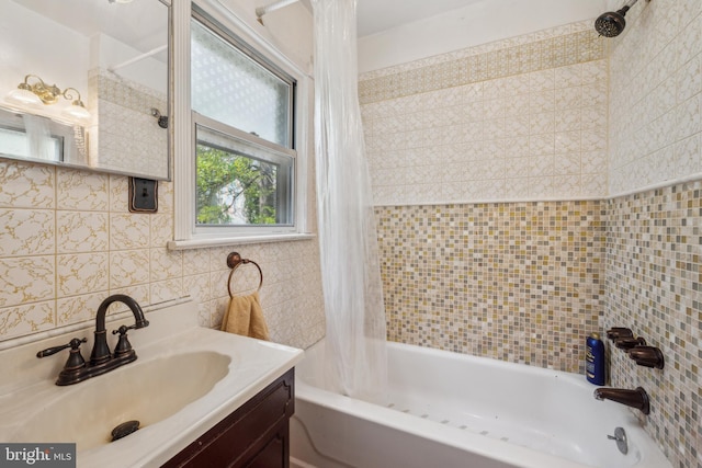 bathroom featuring vanity, shower / bath combination with curtain, and tile walls