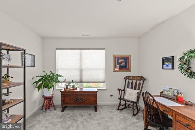 office area featuring light colored carpet, visible vents, and baseboards