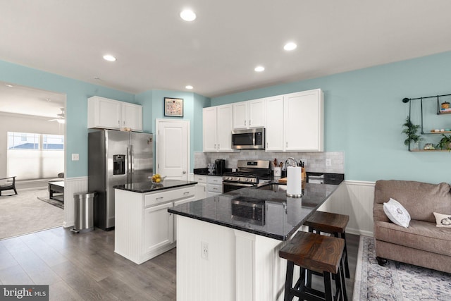 418 N Stokes, Havre De Grace, MD 21078 - kitchen with tasteful backsplash, stainless steel appliances, white cabinetry, a peninsula, and dark wood-type flooring