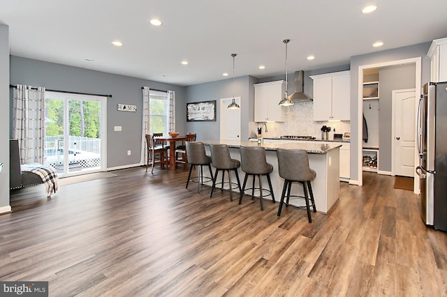 108 Chimney Swift Rd, Fredericksburg, VA 22406 - kitchen with wall chimney range hood, decorative backsplash, appliances with stainless steel finishes, recessed lighting, and dark wood-type flooring