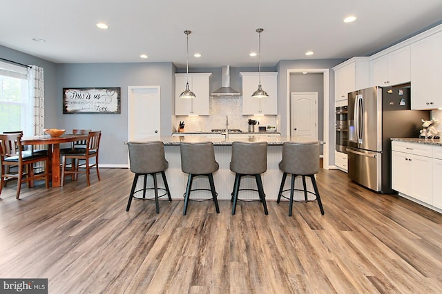 108 Chimney Swift Rd, Fredericksburg, VA 22406 - kitchen with wall chimney range hood, white cabinetry, and wood finished floors