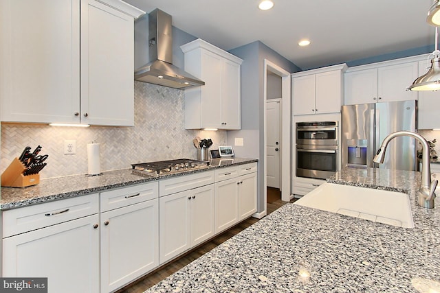 108 Chimney Swift Rd, Fredericksburg, VA 22406 - kitchen featuring wall chimney range hood, white cabinetry, a sink, appliances with stainless steel finishes, and backsplash
