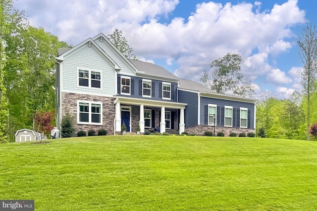 108 Chimney Swift Rd, Fredericksburg, VA 22406 - craftsman-style home with covered porch, a front yard, stone siding, an outbuilding, and a storage shed