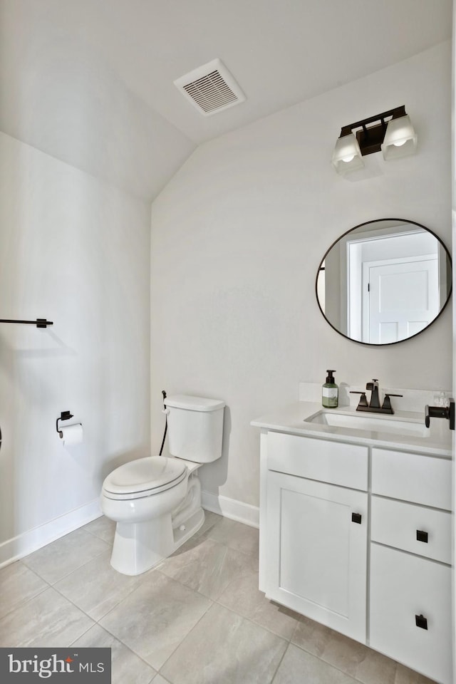 14030 Sunrise Valley Dr, Herndon, VA 20171 - bathroom with lofted ceiling, visible vents, baseboards, toilet, and vanity