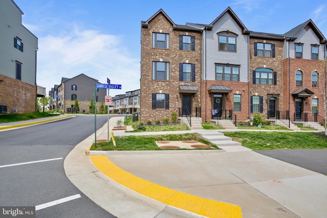 14030 Sunrise Valley Dr, Herndon, VA 20171 - townhome / multi-family property with central air condition unit, a residential view, and brick siding