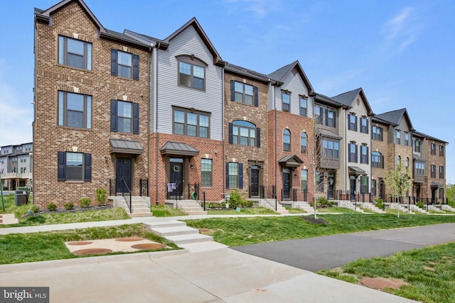 14030 Sunrise Valley Dr, Herndon, VA 20171 - view of front of home with brick siding, a front lawn, and a residential view