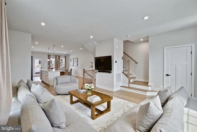 14030 Sunrise Valley Dr, Herndon, VA 20171 - living room featuring recessed lighting, stairway, light wood-style floors, visible vents, and baseboards