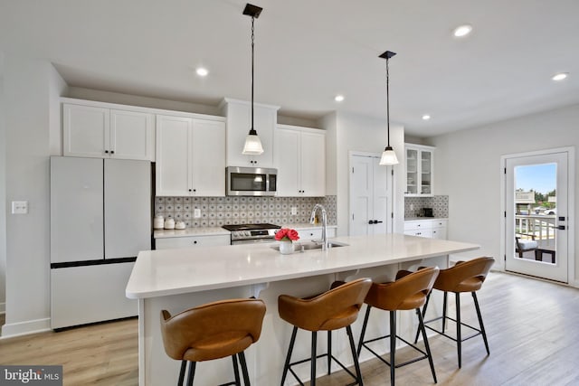 14030 Sunrise Valley Dr, Herndon, VA 20171 - kitchen with a sink, light wood-style flooring, backsplash, white cabinets, and appliances with stainless steel finishes
