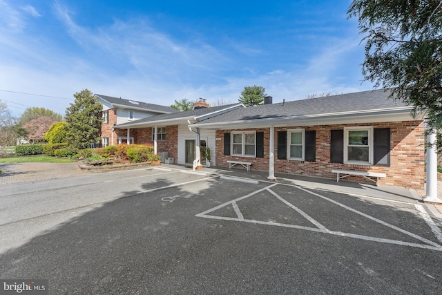 610 Valley Brook Dr, Silver Spring, MD 20904 - view of front of home featuring a chimney, uncovered parking, and brick siding
