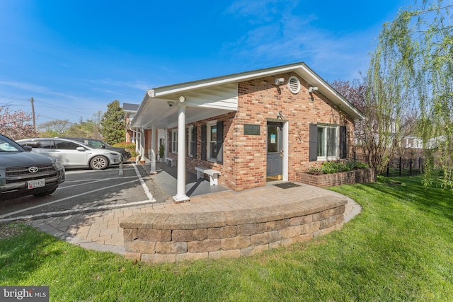 610 Valley Brook Dr, Silver Spring, MD 20904 - rear view of house featuring a lawn, brick siding, and uncovered parking