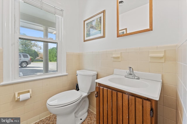 610 Valley Brook Dr, Silver Spring, MD 20904 - bathroom featuring tile walls, a wainscoted wall, vanity, and toilet